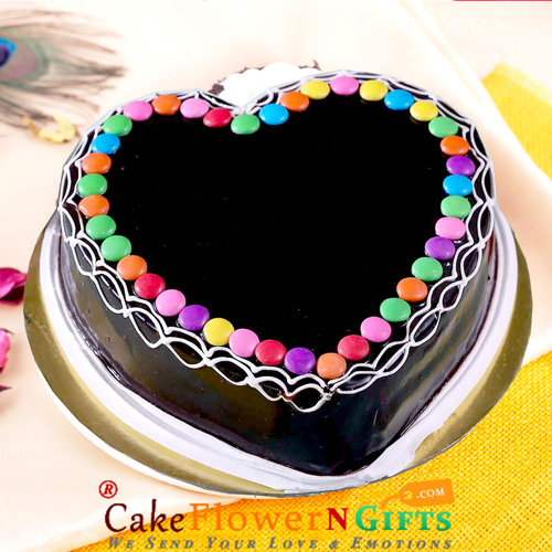 send half kg eggless chocolate  gems heart shape cake delivery