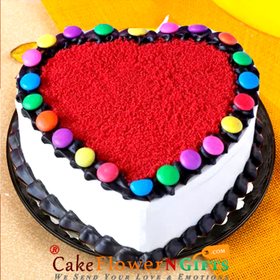 send half kg eggless red velvet heart shape gems cake delivery