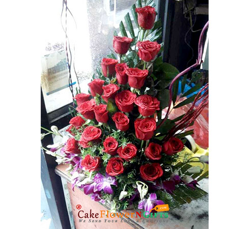 send 21 red roses 3 purple orchids in basket delivery